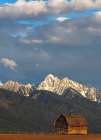 Old wooden barn and Mission Mountains near Pablo, Montana, USA. Art Print